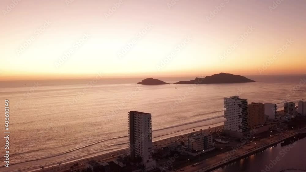 Flying towards from beautiful beach front high rise buildings at sunset Flying towards from beautiful beach front high rise buildings at sunset