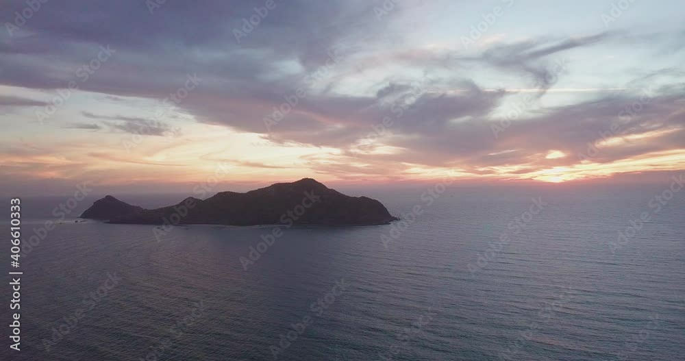 Beautiful view of small island in ocean at sunset Beautiful view of small island in ocean at sunset
