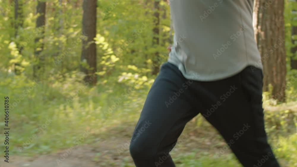 Young handsome man in sportswear running in park while training outdoors in the morning Young handsome man in sportswear running in park while training outdoors in the morning