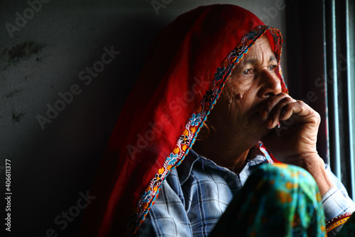 Photography Old Indian women traveling in train alone.