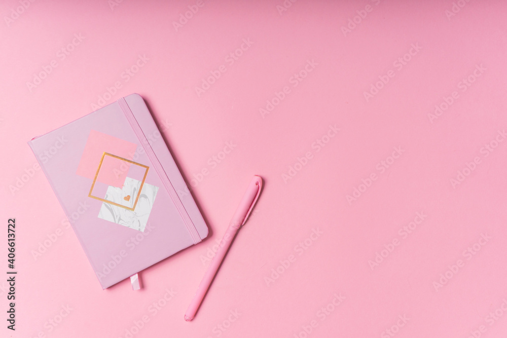 selective focus. Valentine's day layout. pink notepad with copyspace. on a pink paper background with stationery. the view from the top selective focus. Valentine's day layout. pink notepad with copyspace. on a pink paper background with stationery. the view from the top
