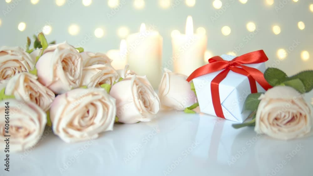 Gift box with beautiful sweet beige rose and romantic candle on bokeh lights background for Valentine day. Gift box with beautiful sweet beige rose and romantic candle on bokeh lights background for Valentine day.
