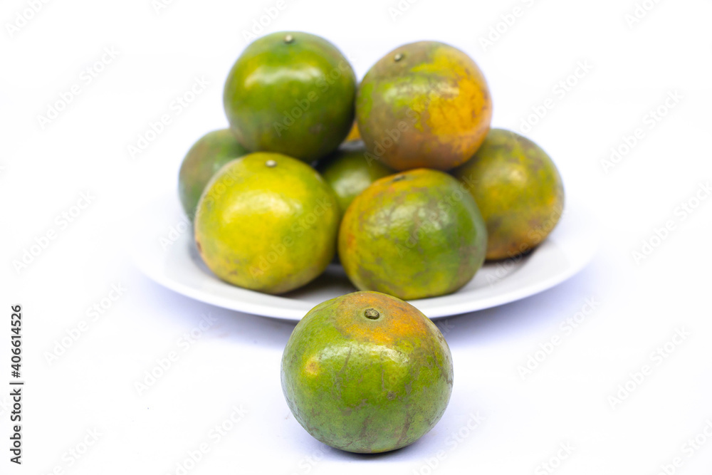 Obraz premium green orange on whtie dish