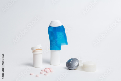 Eye care set of drops and pills in bottles placed with contact lenses container on white background in studio 