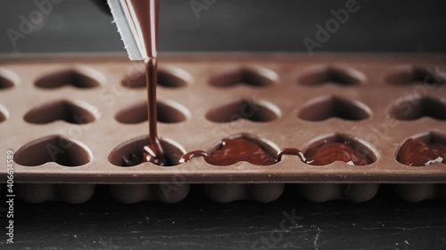 Close-up, melted chocolate poured into a silicone mold, making chocolates, chocolate dessert. Home confectionery.