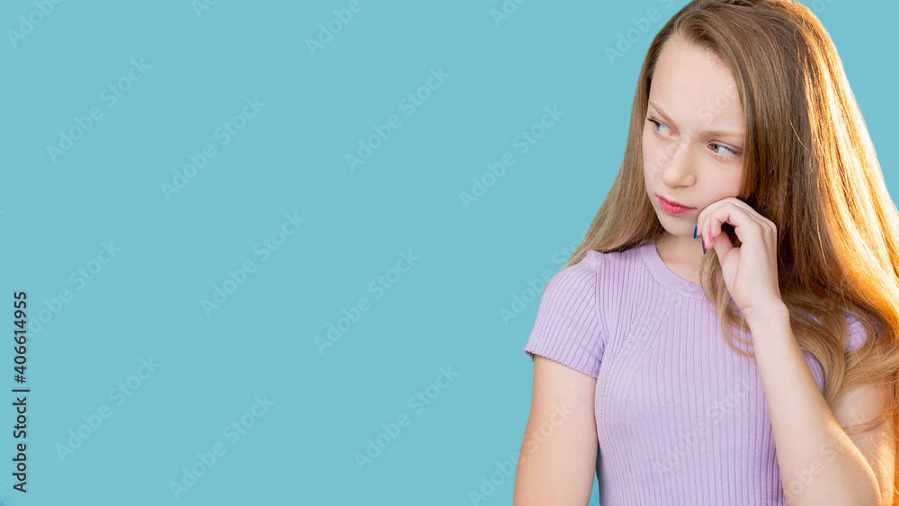 Pensive child. Advertising background. Hard choice. Tough decision. Portrait of doubtful confused young girl thinking considering invisible option isolated on blue copy space. Pensive child. Advertising background. Hard choice. Tough decision. Portrait of doubtful confused young girl thinking considering invisible option isolated on blue copy space.