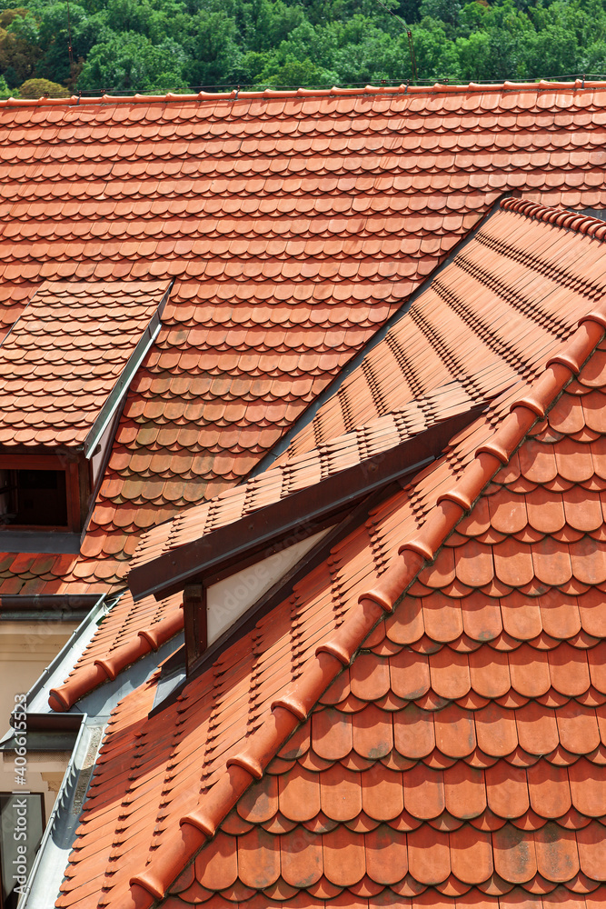 Shingles.Tiled roof.The roof is made of corrugated sheet of red, orange color. The roof is made of a wavy profile.