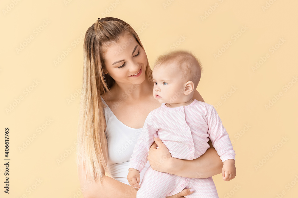 Happy mother with cute little baby on color background Happy mother with cute little baby on color background
