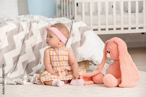 Cute little baby sitting on...