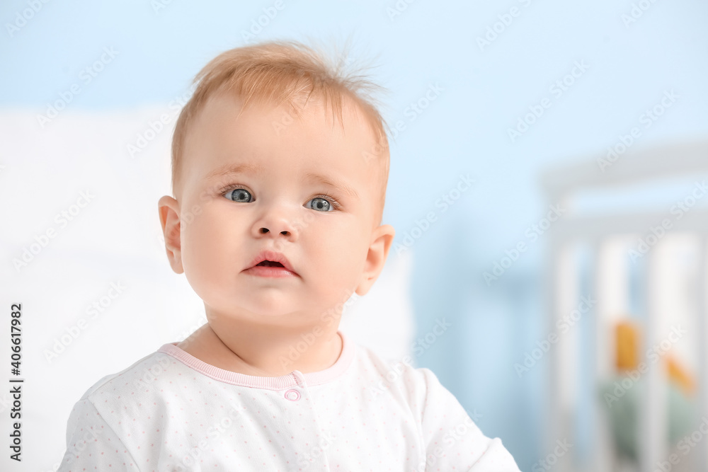 Portrait of cute little baby on blurred background