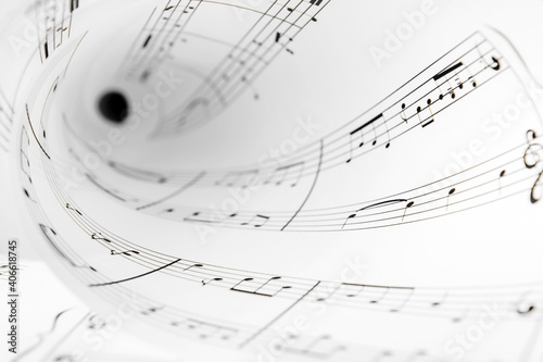 Rolled paper sheet with music notes, closeup