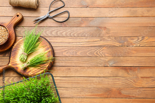 Photos Fresh wheatgrass and seeds in bowl on wooden background