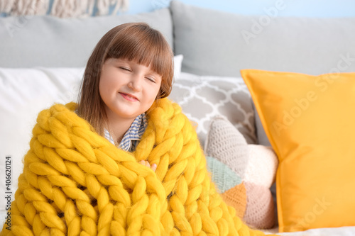 Happy little girl with warm...