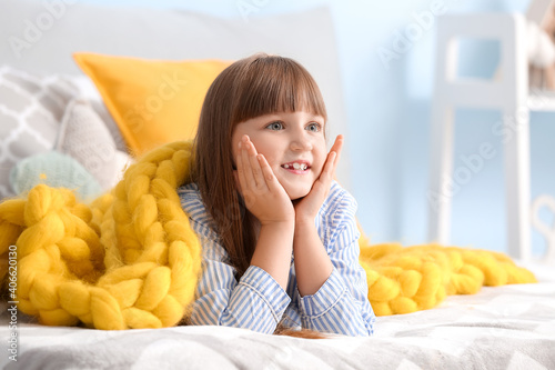 Happy little girl with warm...