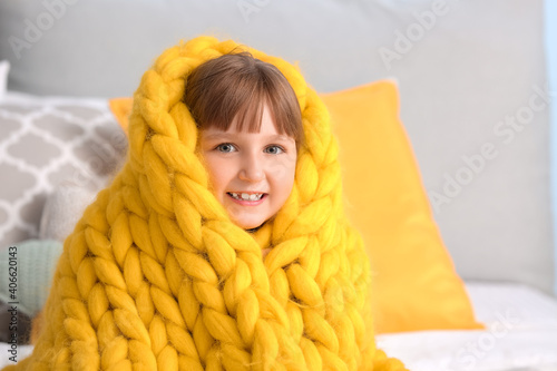 Happy little girl with warm...