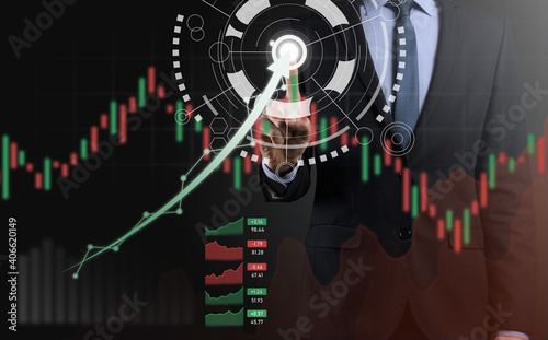Businessman on a black background presses, presses a finger on a positive growth arrow. Graphs of indicators. Business development and finance concept