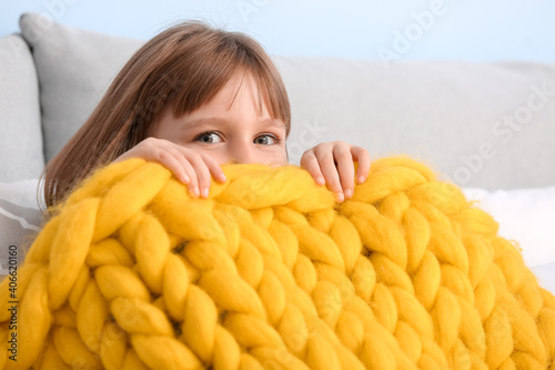 Happy little girl with warm...