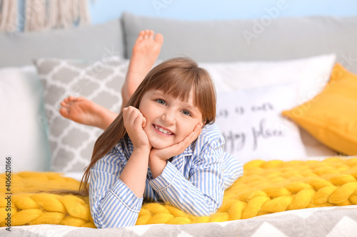 Happy little girl with warm...