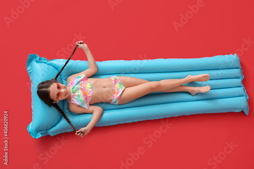 Cute little girl lying on i...
