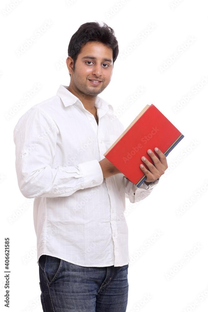 Handsome Indian young man posing with book isolated on white.