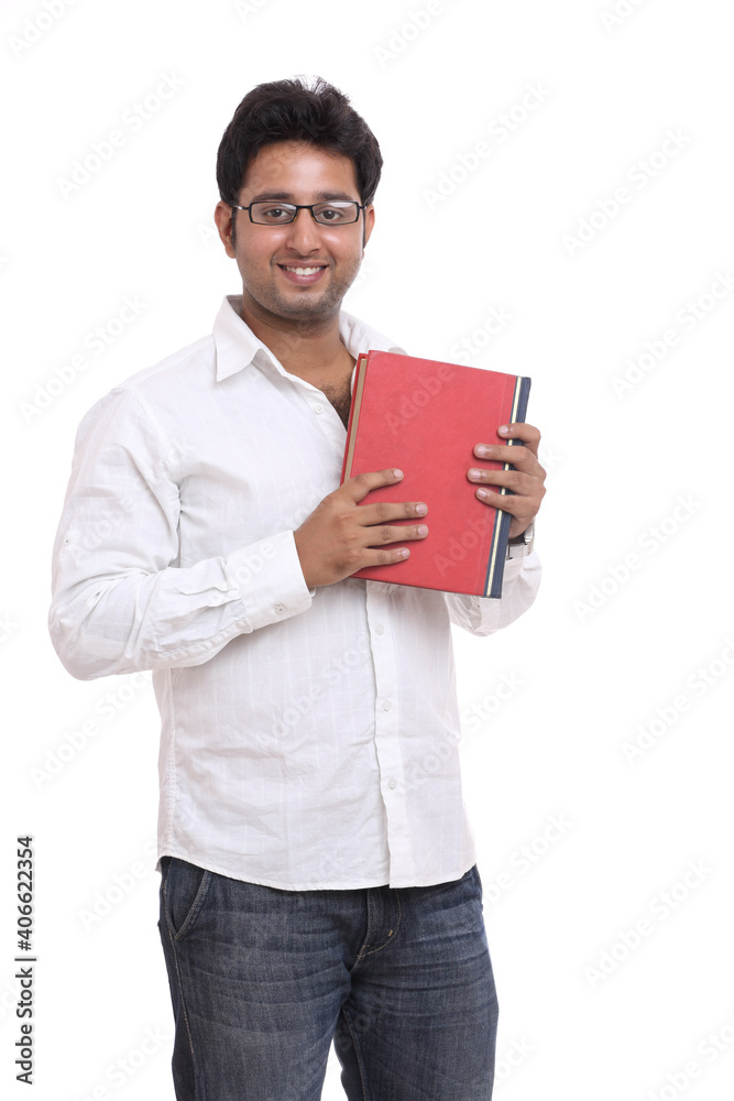 Handsome Indian young man posing with book isolated on white. Handsome Indian young man posing with book isolated on white.