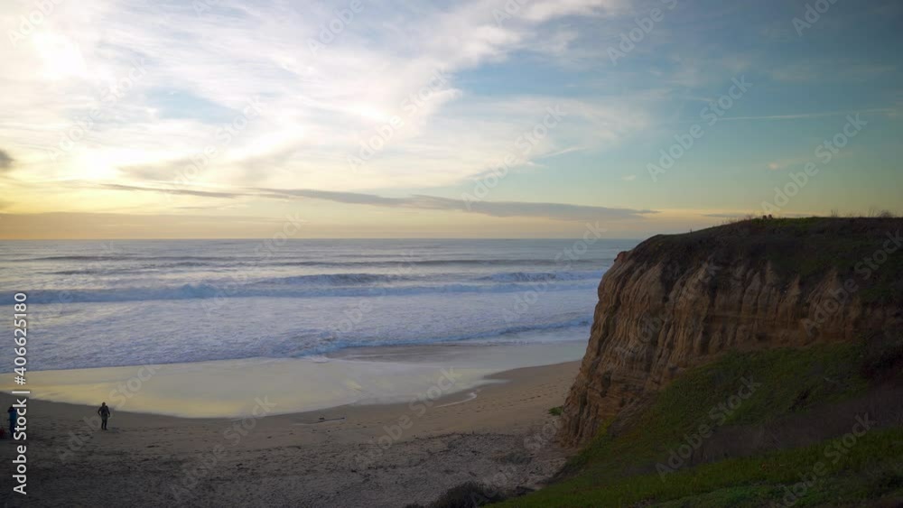 Colorful skies and huge cliff at sunset.