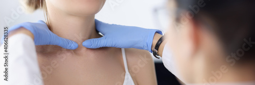 Doctor examines the patient's thyroid gland. Examination of the thyroid gland concept photo