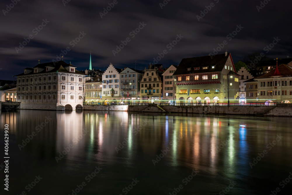 Picturesque night view of town hall and historical buildings on Limmat river quay, Zurich, Switzerland