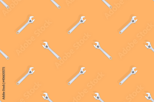 Adjustable metal wrench seamless pattern. Adjustable metal wrench on a colored background.