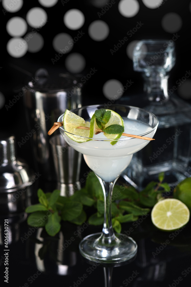 Tequila, Citrus liquor, lime juice - this is a Margarita cocktail. A of lime with a sprig of mint decorates a glass. Dark moody food Tequila, Citrus liquor, lime juice - this is a Margarita cocktail. A of lime with a sprig of mint decorates a glass. Dark moody food