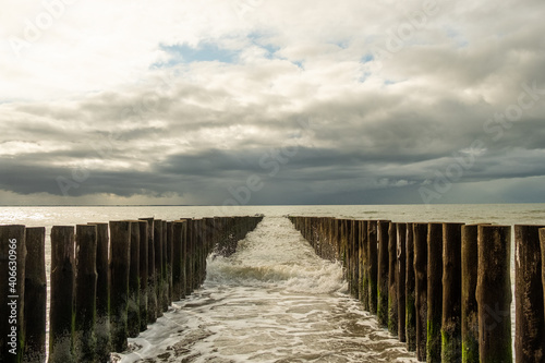 Breakwaters and waves, coast of Zeeland, Netherlands. © Lumenda