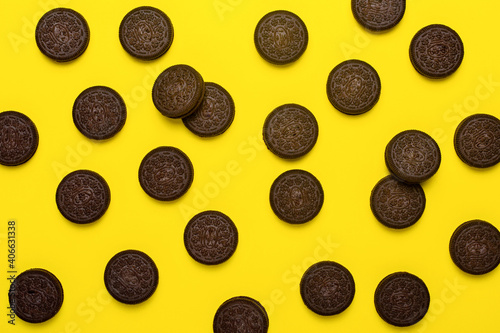 Chocolate chip cookies on yellow background, flat lay, top view.