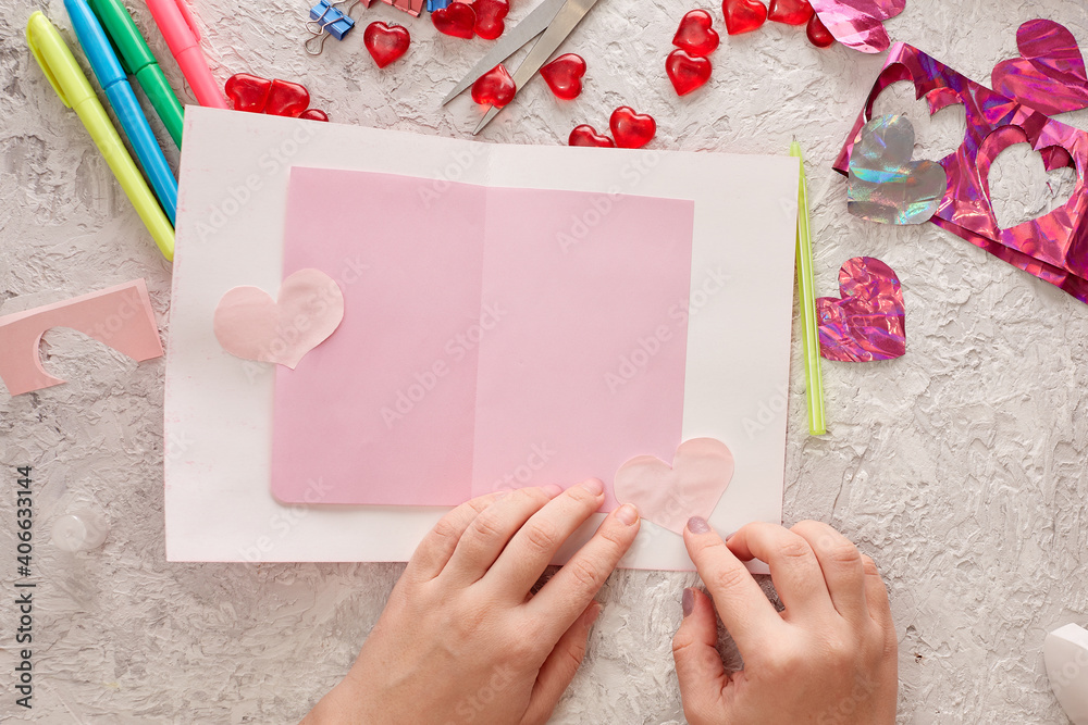 Making a handmade valentine greeting card from colored paper. Children's crafts, hobby concept, gift with your own hands. Valentine's Day Decoration
