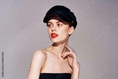 Elegant woman in black evening dress fashion cosmetics hat on head isolated background © SHOTPRIME STUDIO