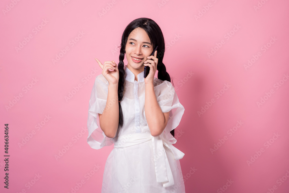 Happy cheerful young woman wearing her black hair rejoicing at positive news or birthday gift, looking at camera with joyful and charming smile. Asian girl portrait on pink background in studio Happy cheerful young woman wearing her black hair rejoicing at positive news or birthday gift, looking at camera with joyful and charming smile. Asian girl portrait on pink background in studio