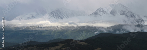 Mountains in the fog, natural light. Panoramic view.