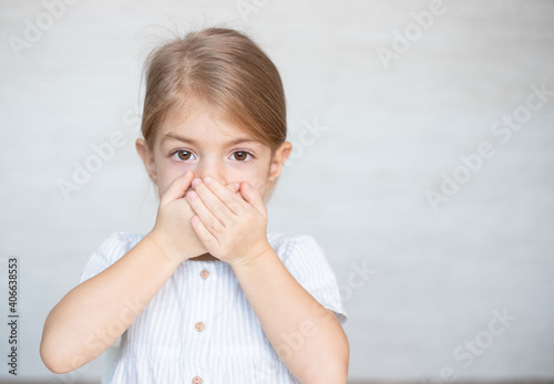 Photography Little girl closing her mouth with hands