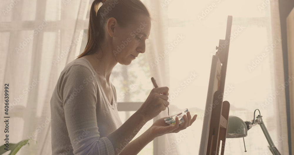 Artist painting on canvas with spatula Artist painting on canvas with spatula