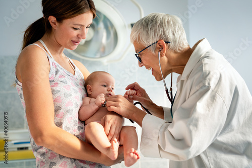 Pediatrician doctor examines baby. Healthcare, people, examination concept