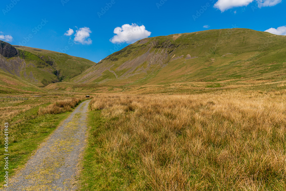 A footpath in the Howgill Fells with Cautley Spout in the background, near Low Haygarth, Cumbria, England, UK A footpath in the Howgill Fells with Cautley Spout in the background, near Low Haygarth, Cumbria, England, UK