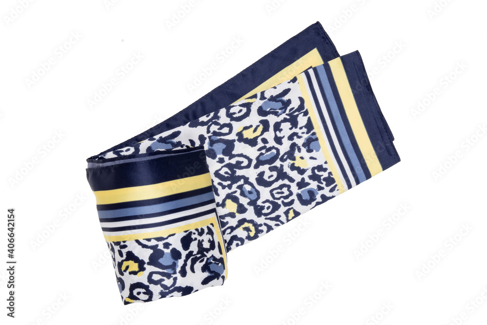 Silk scarf isolated. Closeup of a beautifully wrapped multicolored blue yellow silk scarf or headscarf with a pattern isolated on a white background. Silk scarf isolated. Closeup of a beautifully wrapped multicolored blue yellow silk scarf or headscarf with a pattern isolated on a white background.