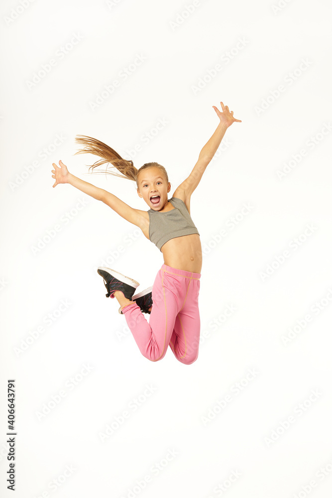Adorable sporty girl jumping and screaming with joy