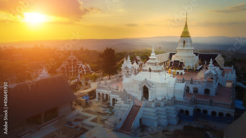 View over the temples of Chaiyaphum in Thailand to the surrounding mountains at sunset