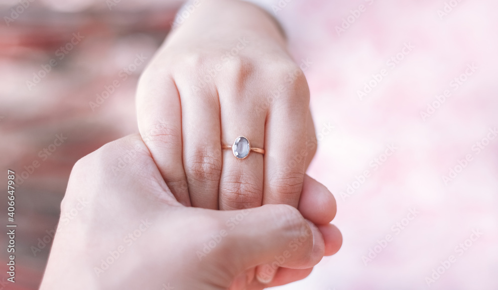 Hands of men and women wearing wedding rings, tone pink. Hands of men and women wearing wedding rings, tone pink.