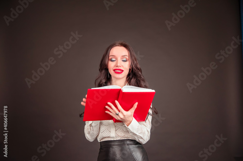 Modern business woman holds a notebook in hand