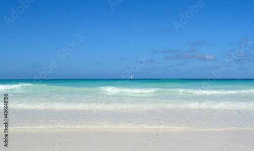 Sailboat at the Atlantic Ocean gliding over the wave ocean surface.Turquoise water view from powder white sandy beach.   © lenic