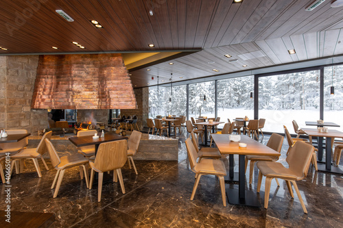 Interior of an empty mountain restaurant with fireplace