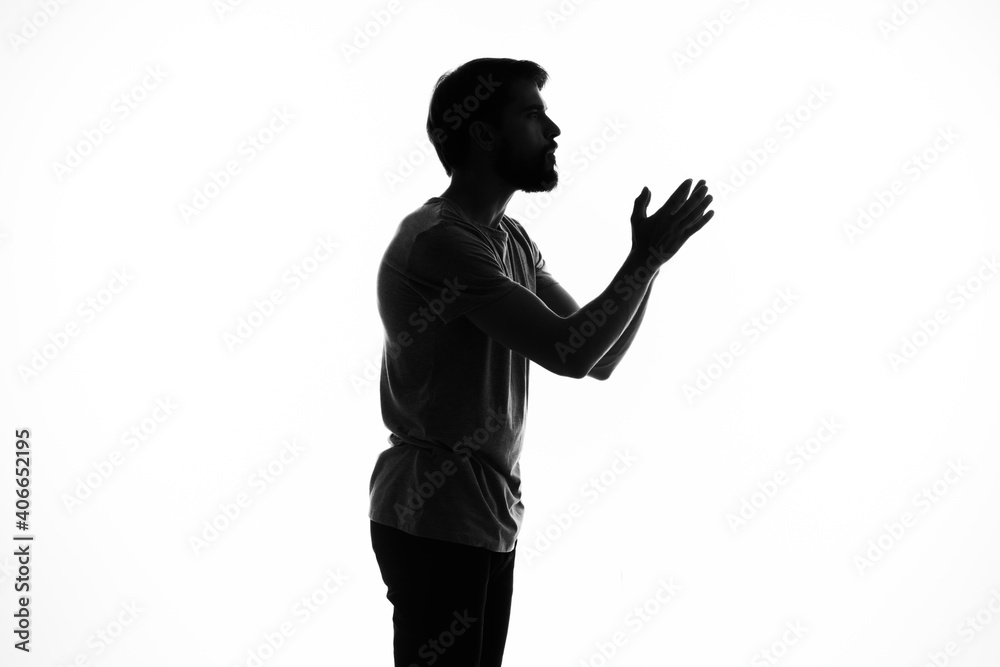 the dark silhouette of a man gesticulate with his hands white background Copy Space