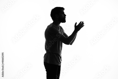 the dark silhouette of a man gesticulate with his hands white background Copy Space