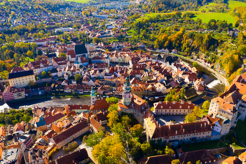 Aerial view of historical centre of Cesky Krumlov town on Vltava riverbank on autumn day overlooking medieval Castle, Czech Republic